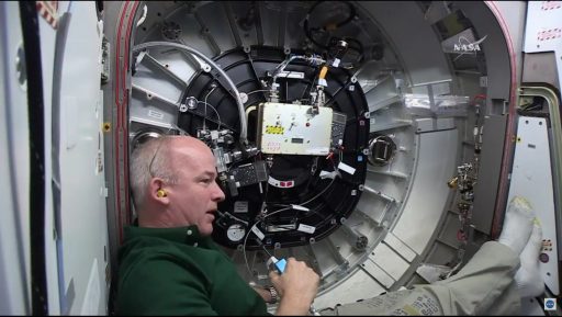 Jeff Williams working in the hatchway to BEAM - Photo: NASA TV
