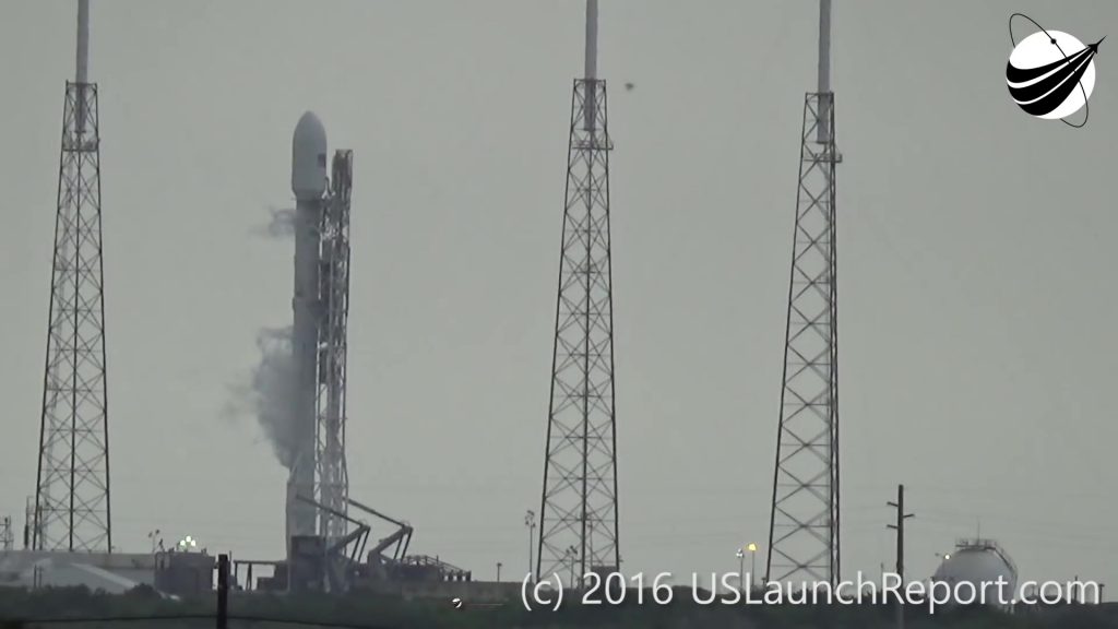 The last video frame before the energetic event transpires near the second stage of the Falcon 9 rocket