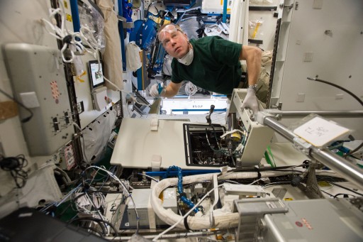 Tim Kopra conducting Urine Processing Assembly - Photo: NASA
