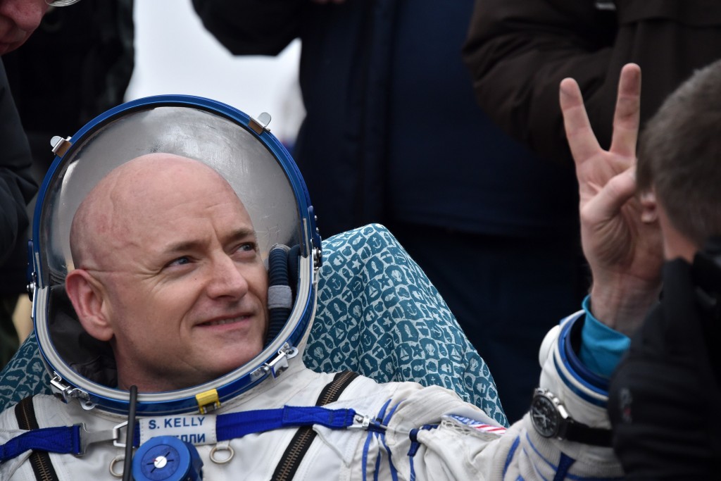 International Space Station (ISS) crew member Scott Kelly of the U.S. shows a victory sign after landing near the town of Dzhezkazgan, Kazakhstan, on March 2, 2016. US astronaut Scott Kelly and Russian cosmonaut Mikhail Kornienko returned to Earth on March 2 after spending almost a year in space in a ground-breaking experiment foreshadowing a potential manned mission to Mars. AFP PHOTO / POOL / KIRILL KUDRYAVTSEV