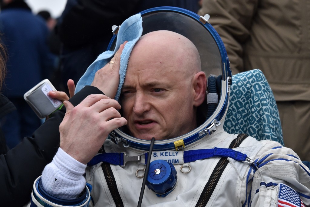 International Space Station (ISS) crew member Scott Kelly of the U.S. reacts after landing near the town of Dzhezkazgan, Kazakhstan, on March 2, 2016. US astronaut Scott Kelly and Russian cosmonaut Mikhail Kornienko returned to Earth on March 2 after spending almost a year in space in a ground-breaking experiment foreshadowing a potential manned mission to Mars. AFP PHOTO / POOL / KIRILL KUDRYAVTSEV