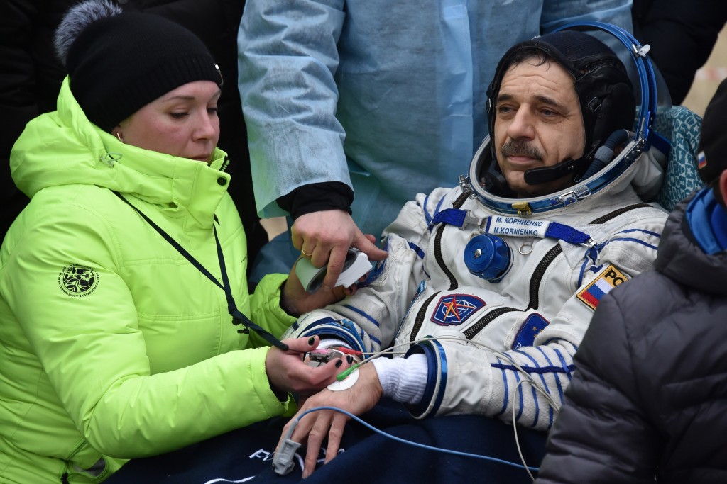 Medics check International Space Station (ISS) crew member Mikhail Kornienko of Russia after landing near the town of Dzhezkazgan, Kazakhstan, on March 2, 2016. US astronaut Scott Kelly and Russian cosmonaut Mikhail Kornienko returned to Earth on March 2 after spending almost a year in space in a ground-breaking experiment foreshadowing a potential manned mission to Mars. AFP PHOTO / POOL / KIRILL KUDRYAVTSEV