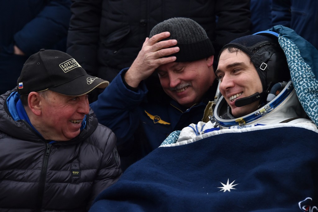International Space Station (ISS) crew member Sergei Volkov (R) of Russia looks at his father Soviet cosmonaut Aleksander Volkov (L) after landing near the town of Dzhezkazgan, Kazakhstan, on March 2, 2016. US astronaut Scott Kelly and Russian cosmonaut Mikhail Kornienko returned to Earth on March 2 after spending almost a year in space in a ground-breaking experiment foreshadowing a potential manned mission to Mars. AFP PHOTO / POOL / KIRILL KUDRYAVTSEV