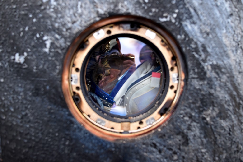 International Space Station (ISS) crew member Mikhail Kornienko of Russia is seen inside the Soyuz TMA-18M space capsule after landing near the town of Dzhezkazgan, Kazakhstan, on March 2, 2016. US astronaut Scott Kelly and Russian cosmonaut Mikhail Kornienko returned to Earth on March 2 after spending almost a year in space in a ground-breaking experiment foreshadowing a potential manned mission to Mars. AFP PHOTO / POOL / KIRILL KUDRYAVTSEV