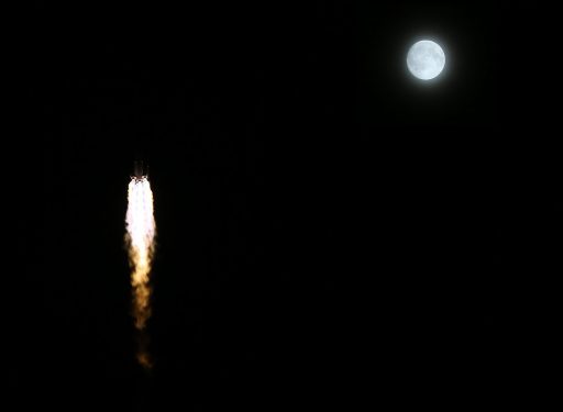 Long March 2F passes the Moon on its way into orbit - Photo: Xinhua (modified by Spaceflight101)
